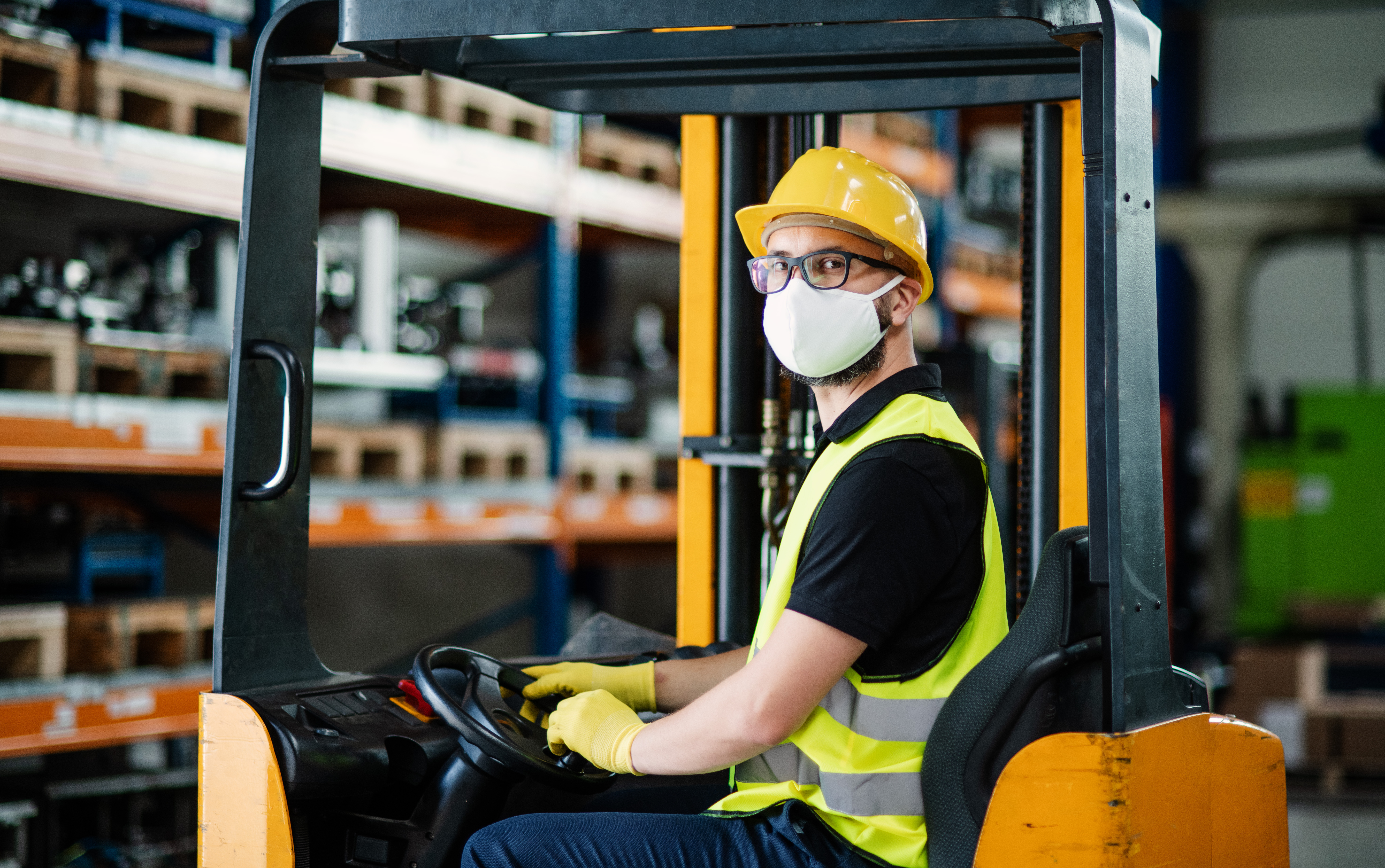 Forklift Driver in Face Mask in a warehouse