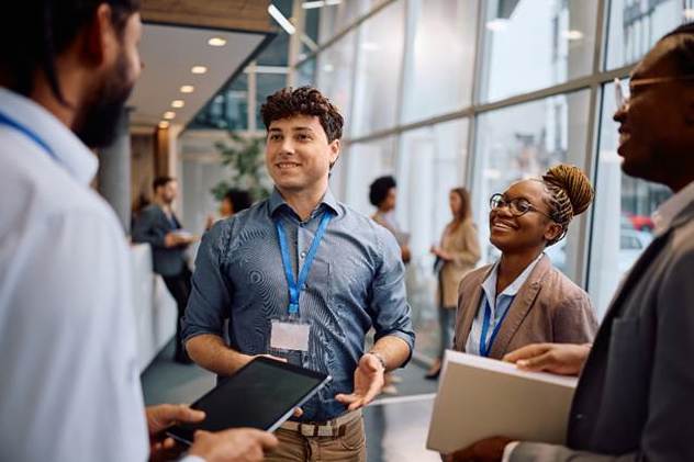 A group of people talking in a room
AI-generated content may be incorrect.